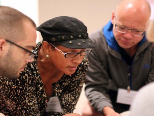 A group of learners have a conversation around a museum object.