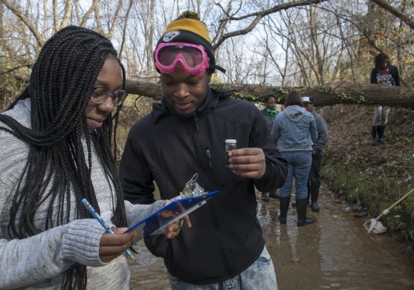 People gathering water samples for citizen science project.