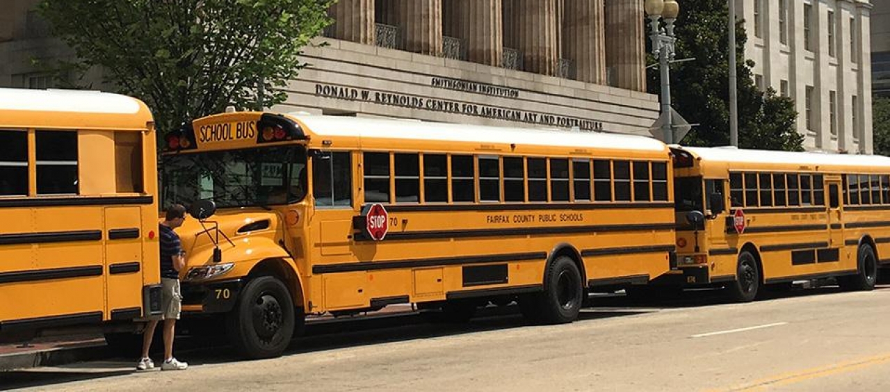 School buses in front of the Smithsonian American Art Museum.